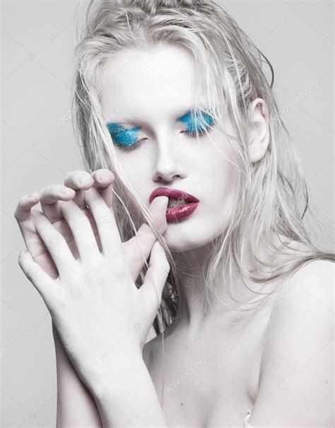 High Fashion Beauty Model Girl With Blue Make Up And Long Lushes Red