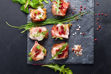 Sliced Prosciutto With Herbs And Pomegranate Seeds Photo Background And