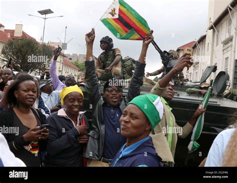 Protesters Calling For Zimbabwean President Robert Mugabe To Step Down Cheer In Front Of A