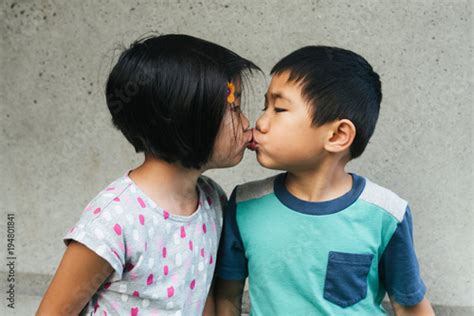 Boy Girl Fraternal Twin Young Children Kissing On The Lips Stock Photo