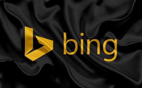 The Bing Logo Is Shown On A Black Satin Background With Gold Foiled
