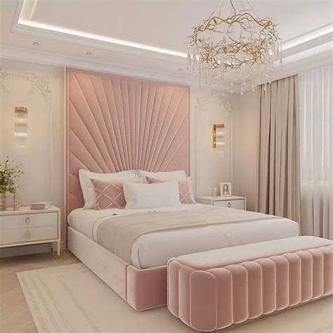 A Bedroom With A Large Bed Chandelier And Pink Velvet Upholstered