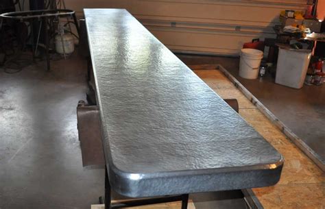Only one thing from the original kitchen survived the renovation. Hammered Zinc Countertop - Mountain Copper Creations