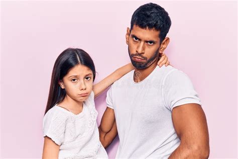 Young Father And Daughter Wearing Casual Clothes Depressed And Worry