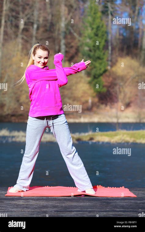 Woman Teenage Girl In Tracksuit Doing Exercise On Pier Outdoor Stock