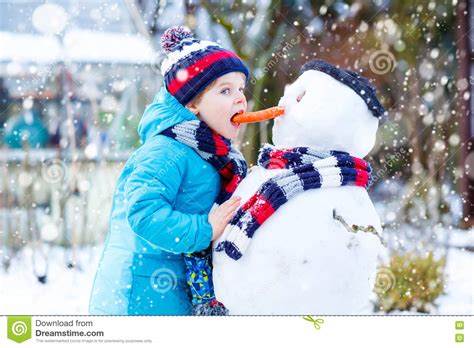 Check out some of these snowman pictures sure to bring a smile to your day. Funny Kid Boy In Colorful Clothes Making A Snowman ...
