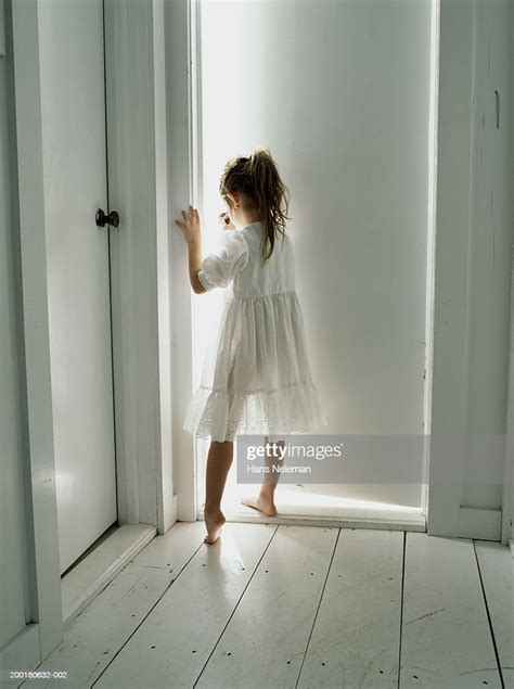 Girl Standing In Front Of Door Rear View Photo Getty Images