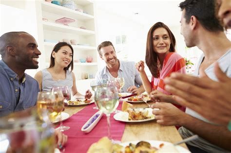 On appetizers and enjoyed a meal and the dessert plates have been cleared from the table, it's game time. Group Of Friends Sitting Around Table Having Dinner Party ...