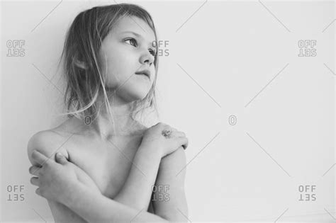 Young Girl Standing With Her Arms Crossed Over Her Bare Chest Stock
