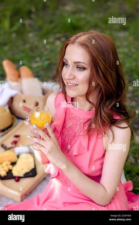 Pretty Young Girl In Park Holding Juice Having Summer Picnic In Park