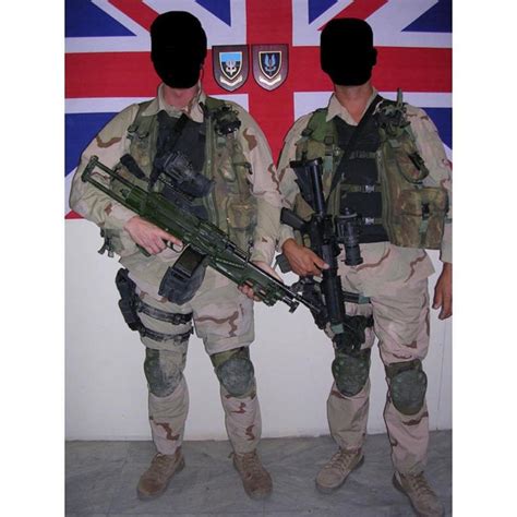 British Sas Personnel Pictured In Front Of A Union Jack And Crests For