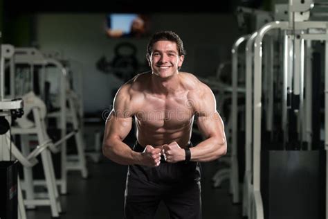 Muscular Man Flexing Muscles In Gym Stock Photo Image Of Brown