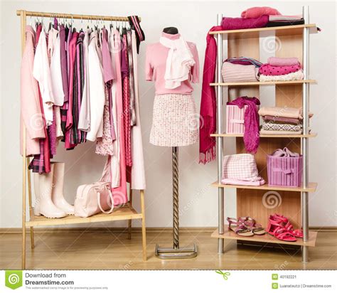 This fashion editor's tale of how she finally purged her closet may convince you to try donating a few things. Dressing Closet With Pink Clothes Arranged On Hangers And ...