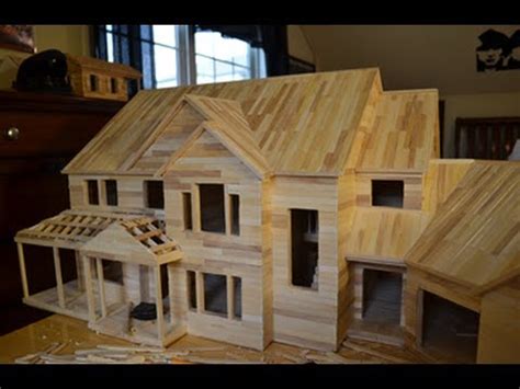 3 full popsicle sticks, 4 half popsicle sticks, lined up horizontally and spaced accordingly for door and window (see photo) and attached to each other with 3 popsicle sticks. Building Popsicle Mansion Time Lapse HD - YouTube