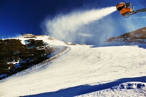 Skier Near A Snow Cannon Making Powder Snow Alps Ski Resort Stock