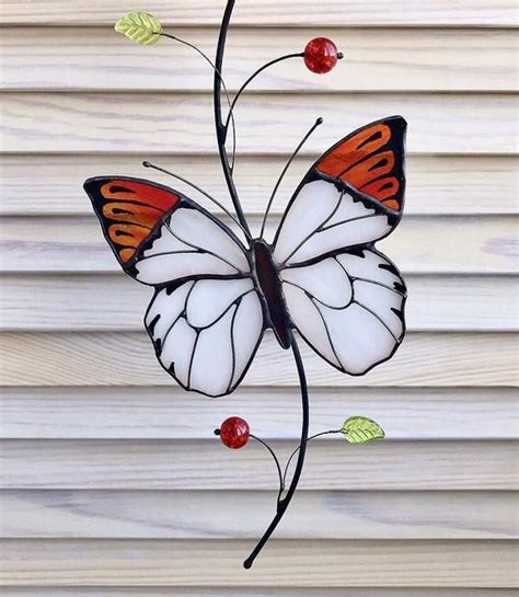Get a 22.000 second white butterfly hanging on a stock footage at 23.98fps. White Butterfly suncatcher from stained glass window ...