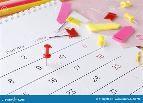Planning Calendar On A Pink Background With Pins Pencils Stickers