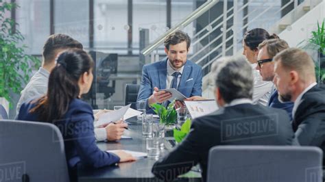 In The Modern Corporate Office Meeting Room Diverse Group Of