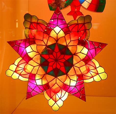 A Multicolored Stained Glass Star Hanging From The Ceiling