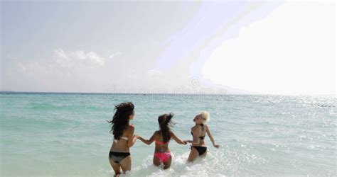 Girls In Bikini Running On Beach Cheerful Women Group Tourists On