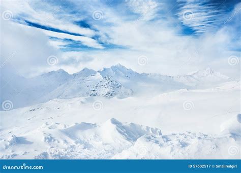 Winter Snow Covered Mountains And Blue Sky With White Clouds Stock
