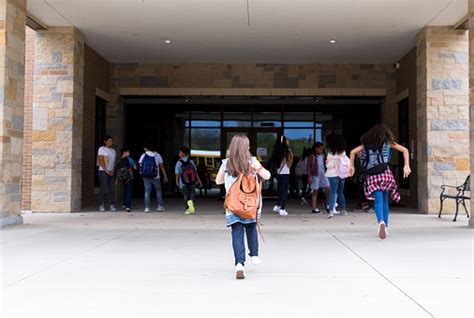 Group Of Student Walking Into School Building Stock Photo Download