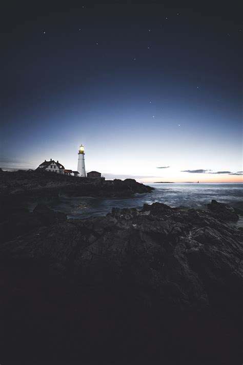 Lighthouse At Night Pictures Download Free Images On Unsplash