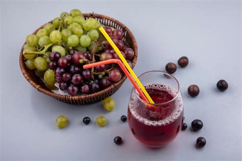 Free Photo Side View Of Black Grape Juice With Drinking Tube In Glass