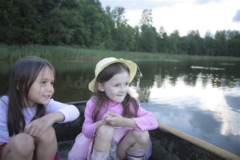 Portrait Of Two Girls In A Boat On The Lake Stock Photo Image Of Kids