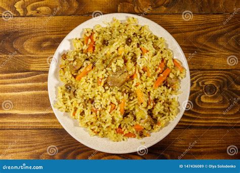 Pilaf With Meat Rice Carrot And Onion In A Plate On Wooden Table Top