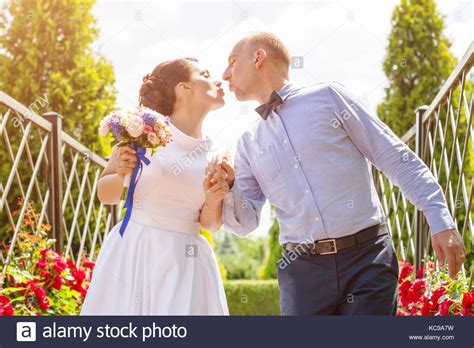 Bride And Groom Kissing Outdoors Wedding Day Of Happy Bridal Couple