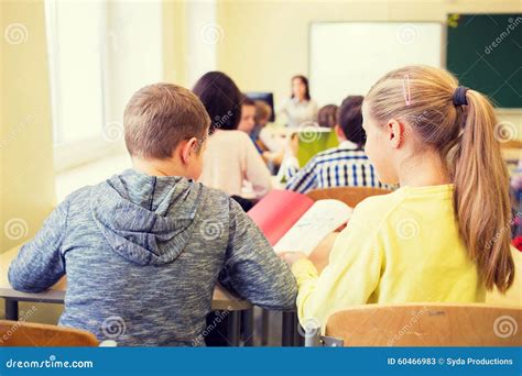 Group Of School Kids Writing Test In Classroom Stock Image Image Of