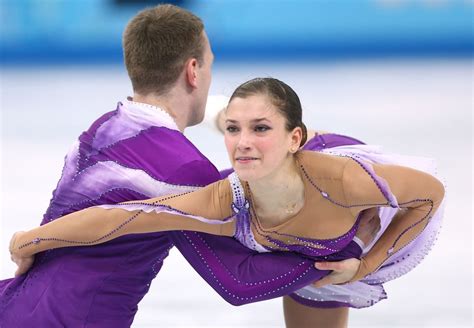 A Man And Woman Figure Skating On An Ice Rink