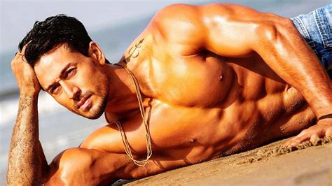 download tiger shroff body while posing on sand wallpaper