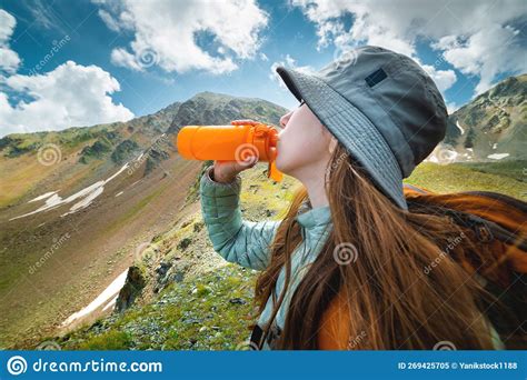 Healthy Female Hiker Drinks Water On A Hike In Nature Beautiful Young