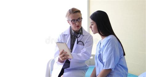 Women Doctor Talk With Woman Patient In His Office At Hospitals