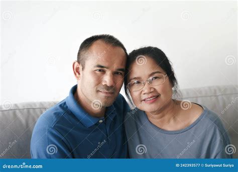 Portrait Of Asian Mature Couple Sitting In The Living Room Wife And