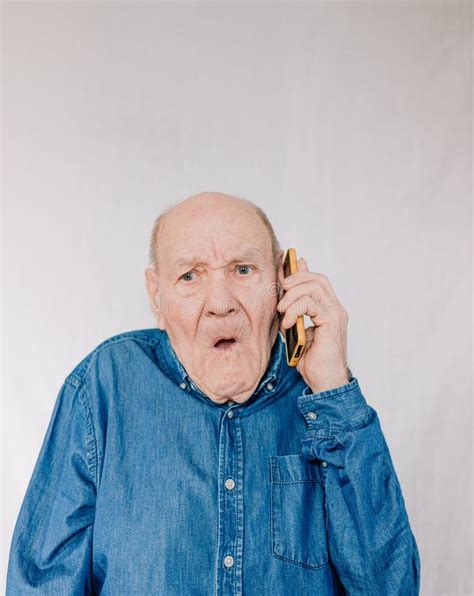 A Large Portrait Of An Old Man In A Blue Shirt Talking In Surprise On