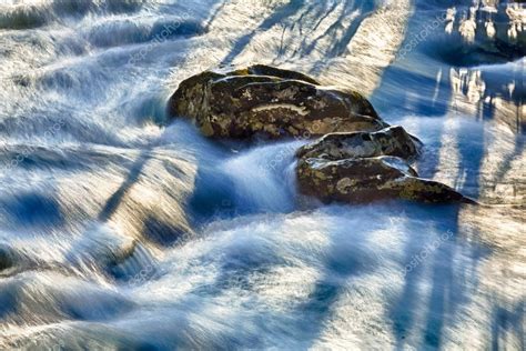 Raging River Flows Around Rocks — Stock Photo © Steveheap 5194590