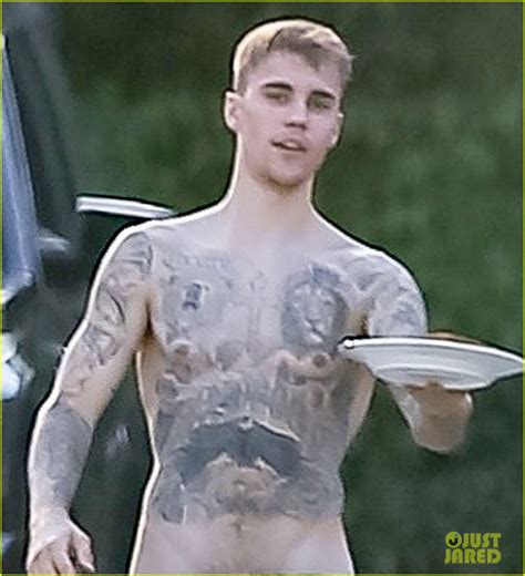 justin bieber goes shirtless in low hanging shorts while bringing a sandwich to his assistant