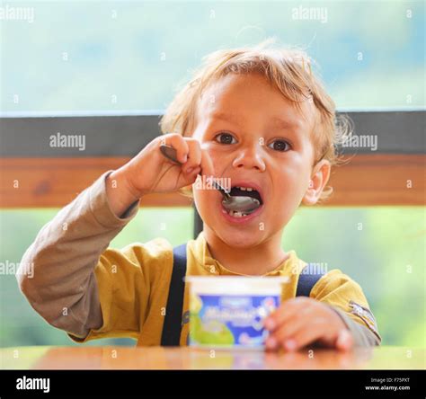 Little Boy Is Eating Yogurt Stock Photo Alamy