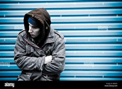 Young Man Wearing A Hooded Jacket Alone And Isolated Looking Vulnerable