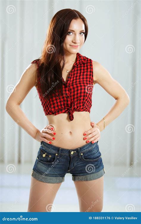 Beautiful Stylish Girl In A Checkered Shirt And Denim Shorts Woman
