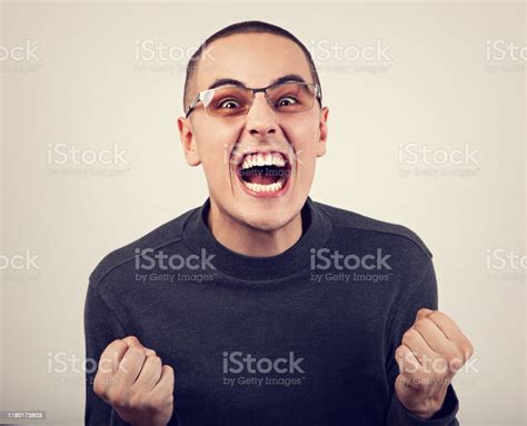 Angry Young Man Shouting With Open Mouth And Very Anger Face Showing