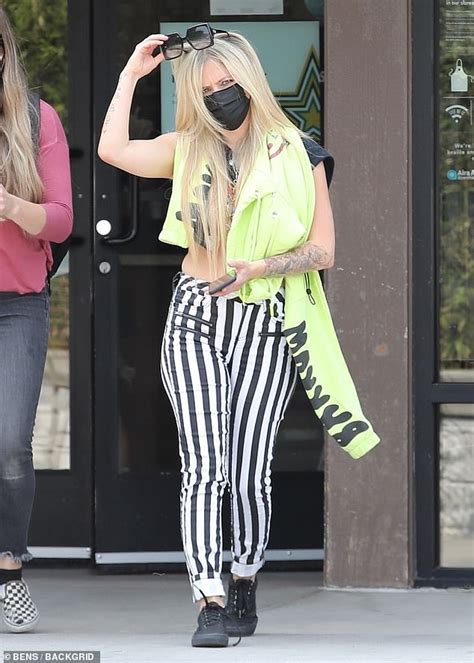 Avril Lavigne Stands Out In Bold Black And White Striped Skinny Pants For Coffee Run In