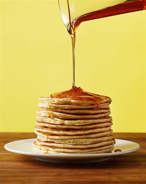 Pouring Maple Syrup On A Stack Of Pancakes By Stocksy Contributor