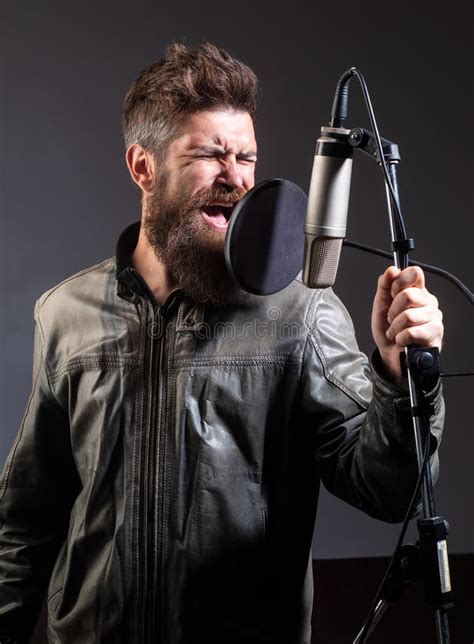 Expressive Singer With Microphone Singer Wearing Headphones Is
