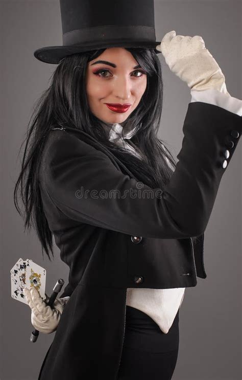 Female Magician In Performer Suit With Magic Wand And Playing Ca Stock