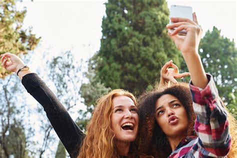 Diverse Girlfriends Taking Selfie In Park By Stocksy Contributor