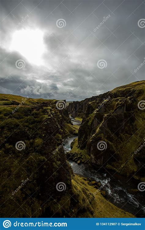 Deep Canyon Steep Cliffs Overgrown With Green Moss Surrounded By A